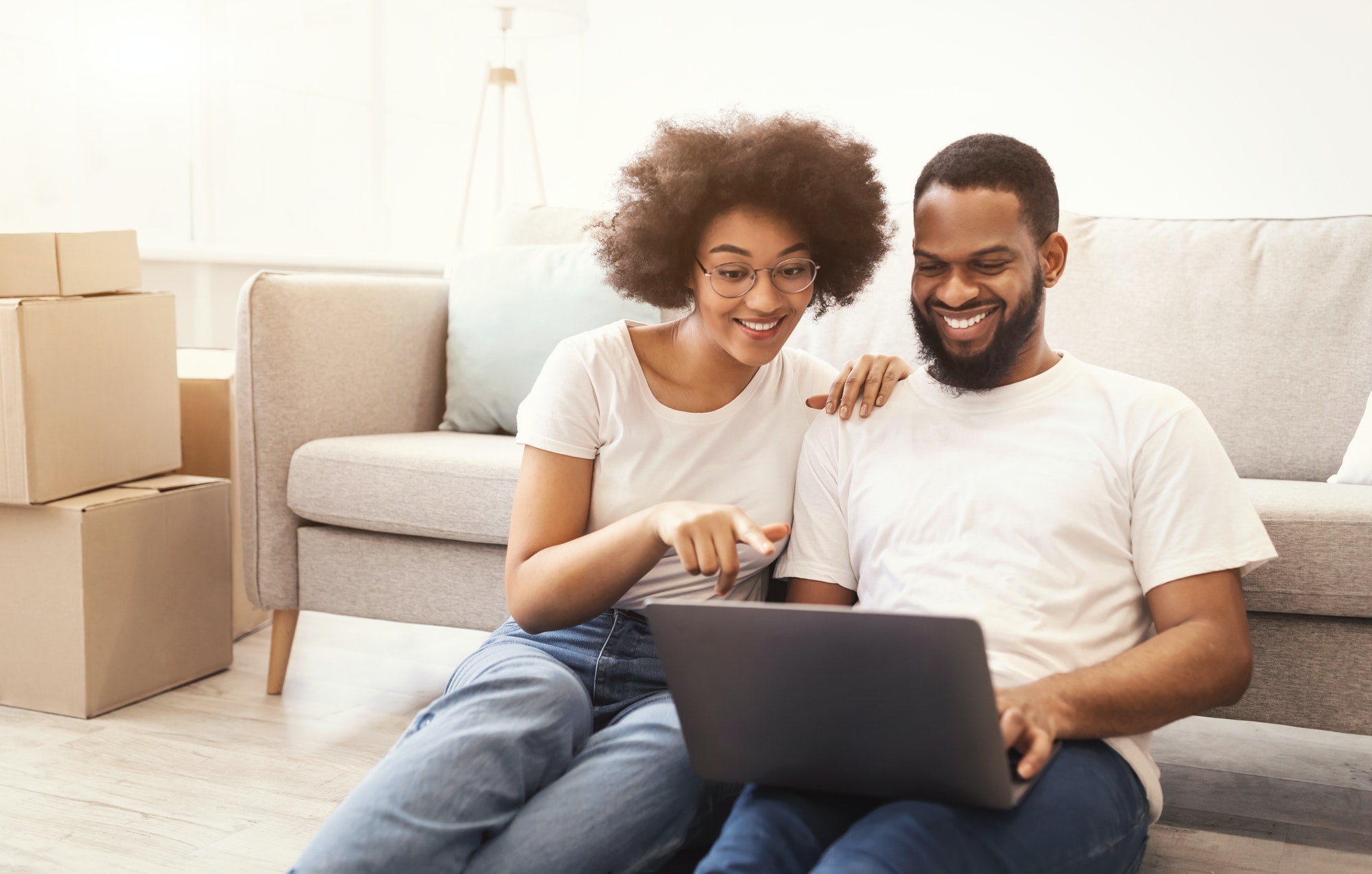 Black Couple Using Laptop Shopping Furniture For House After Relocation